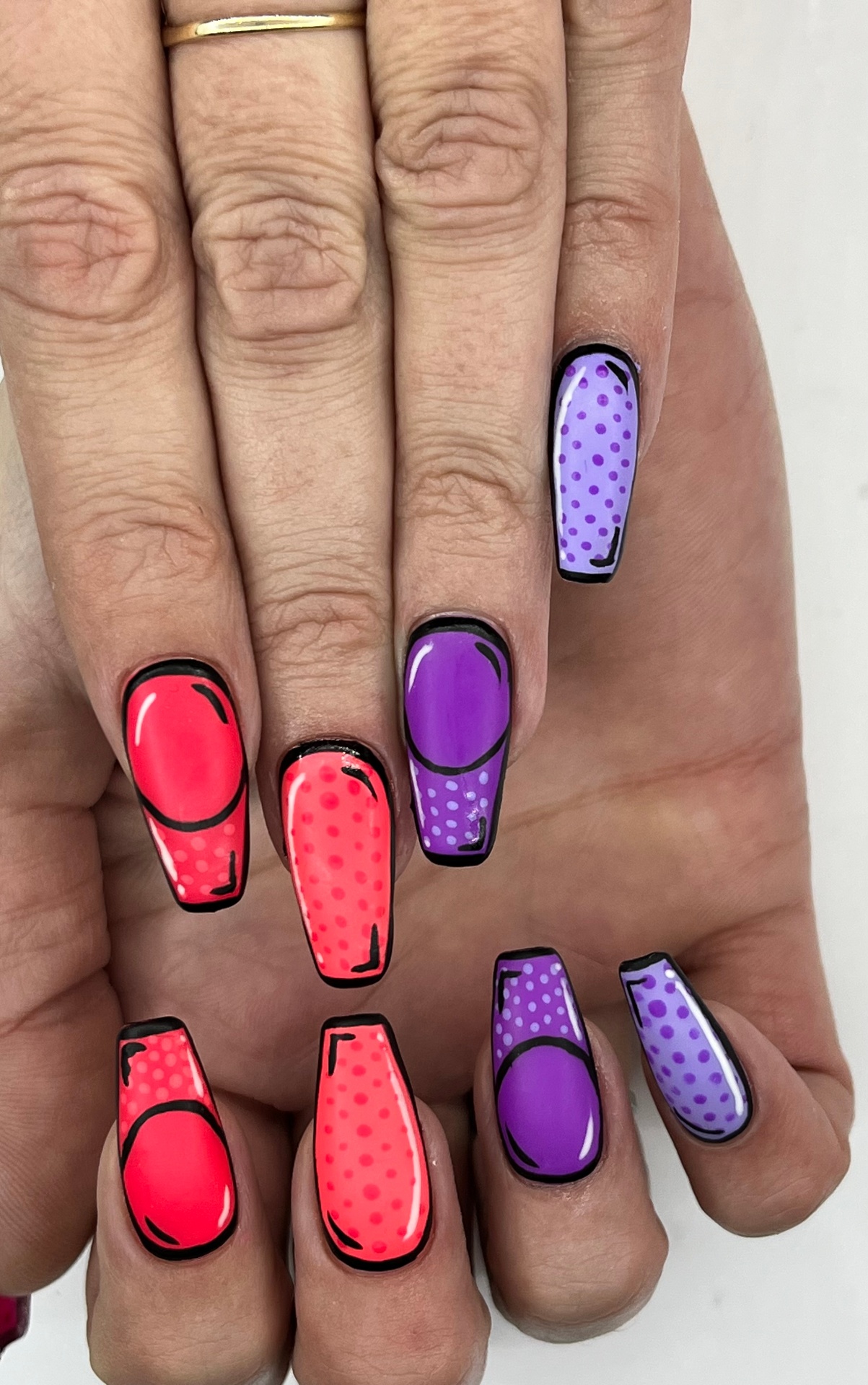Pop-art comic-style coffin nails in red, coral and purple with bold black outlines